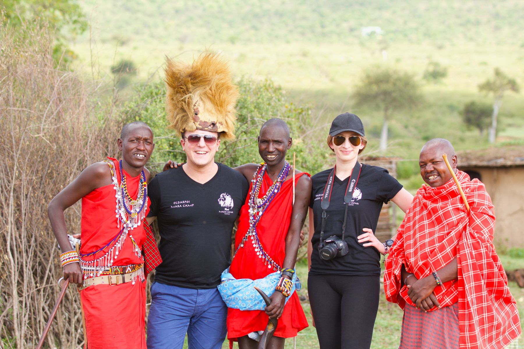 Guests with Maasai hosts in traditional dress at a village near the Mara